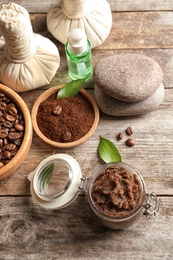 Photo of Composition with handmade natural body scrub and coffee on wooden background