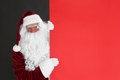 Photo of Santa Claus holding empty banner on black background