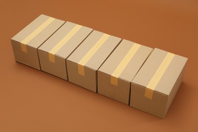 Photo of Group of cardboard boxes on brown background