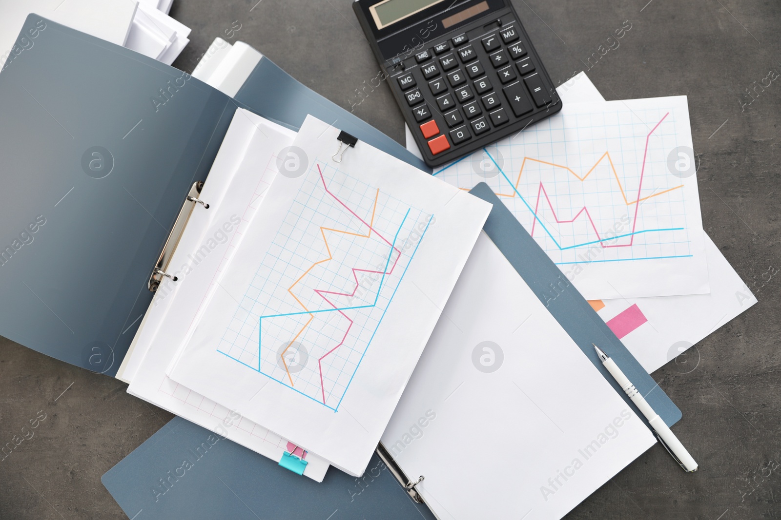 Photo of Folders with documents and calculator on office table, top view