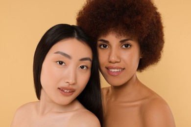 Photo of Portrait of beautiful young women on beige background