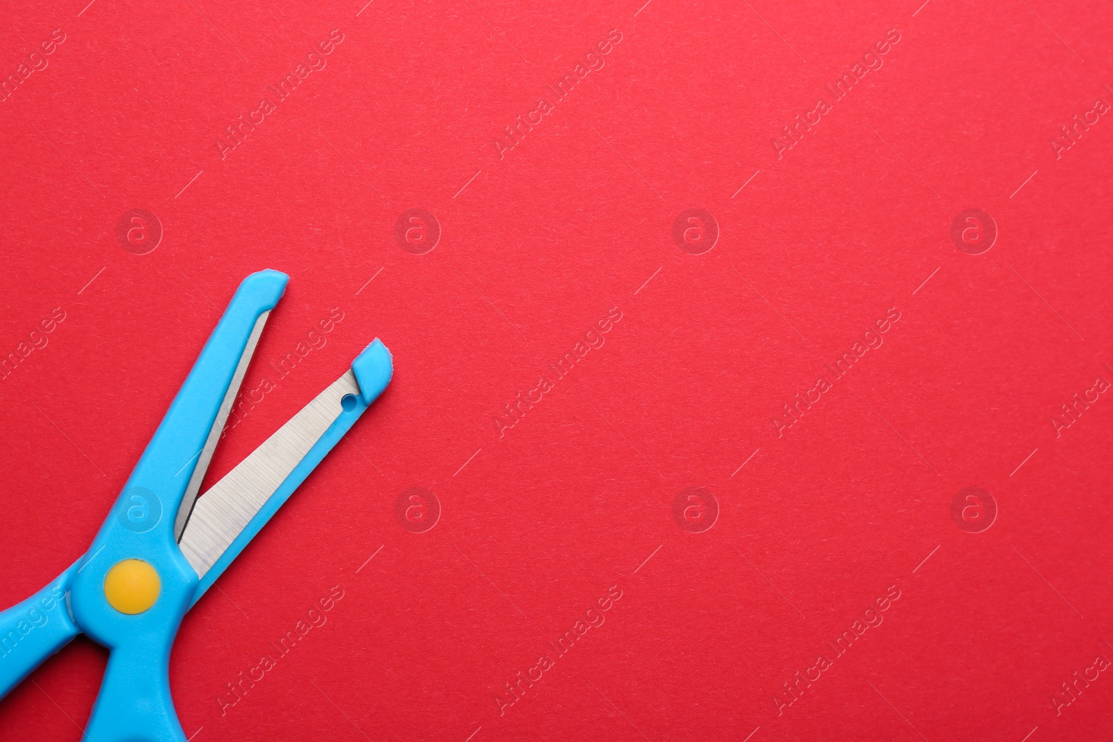 Photo of Training scissors on color background, top view. Space for text