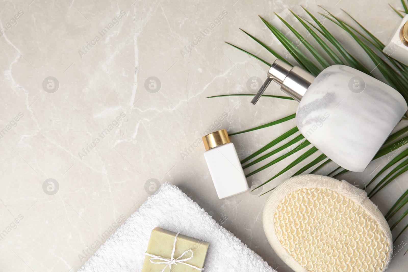 Photo of Flat lay composition with soap dispenser on marble background. Space for text