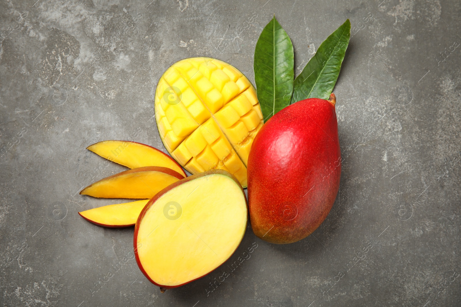 Photo of Flat lay composition with ripe mangoes on grey background