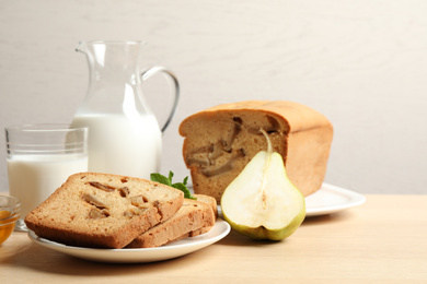 Photo of Composition with tasty pear bread on wooden table. Homemade cake