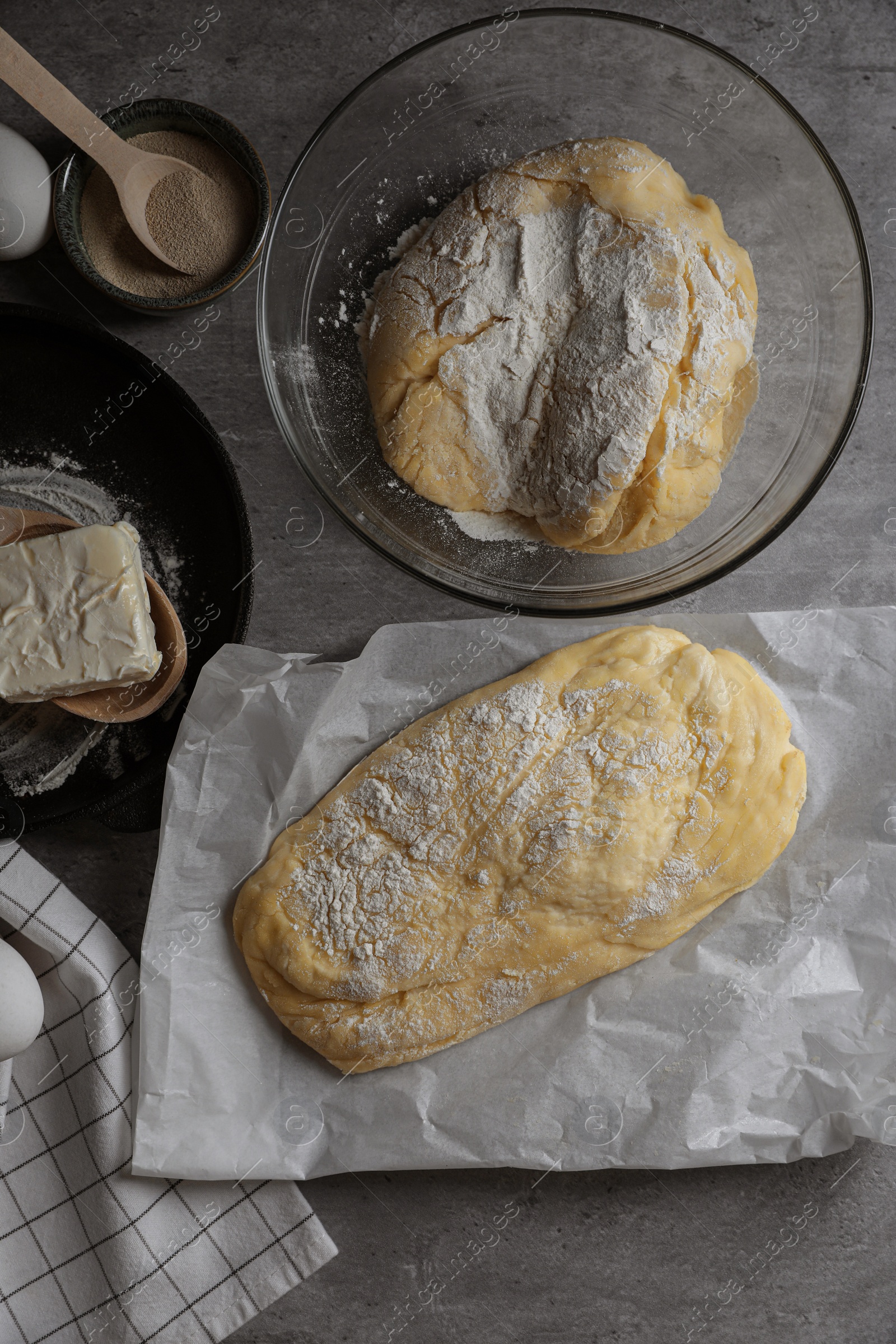 Photo of Dough, eggs and flour on light grey table, flat lay. Cooking ciabatta