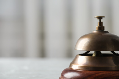 Photo of Hotel service bell on table, closeup. Space for text