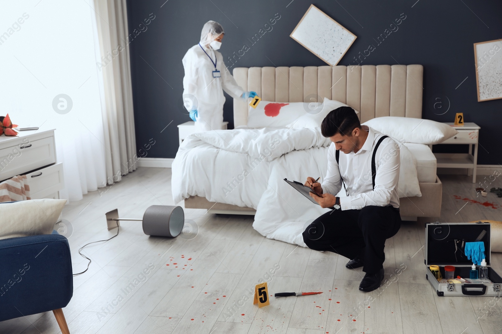 Photo of Investigators working at crime scene in messy room