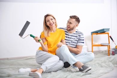Photo of Young couple during apartment renovation, indoors