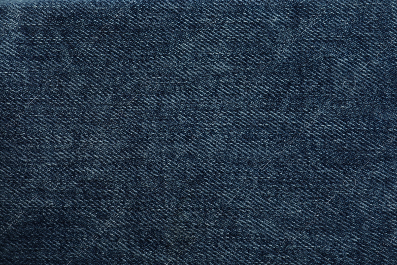 Photo of Texture of dark blue jeans as background, closeup