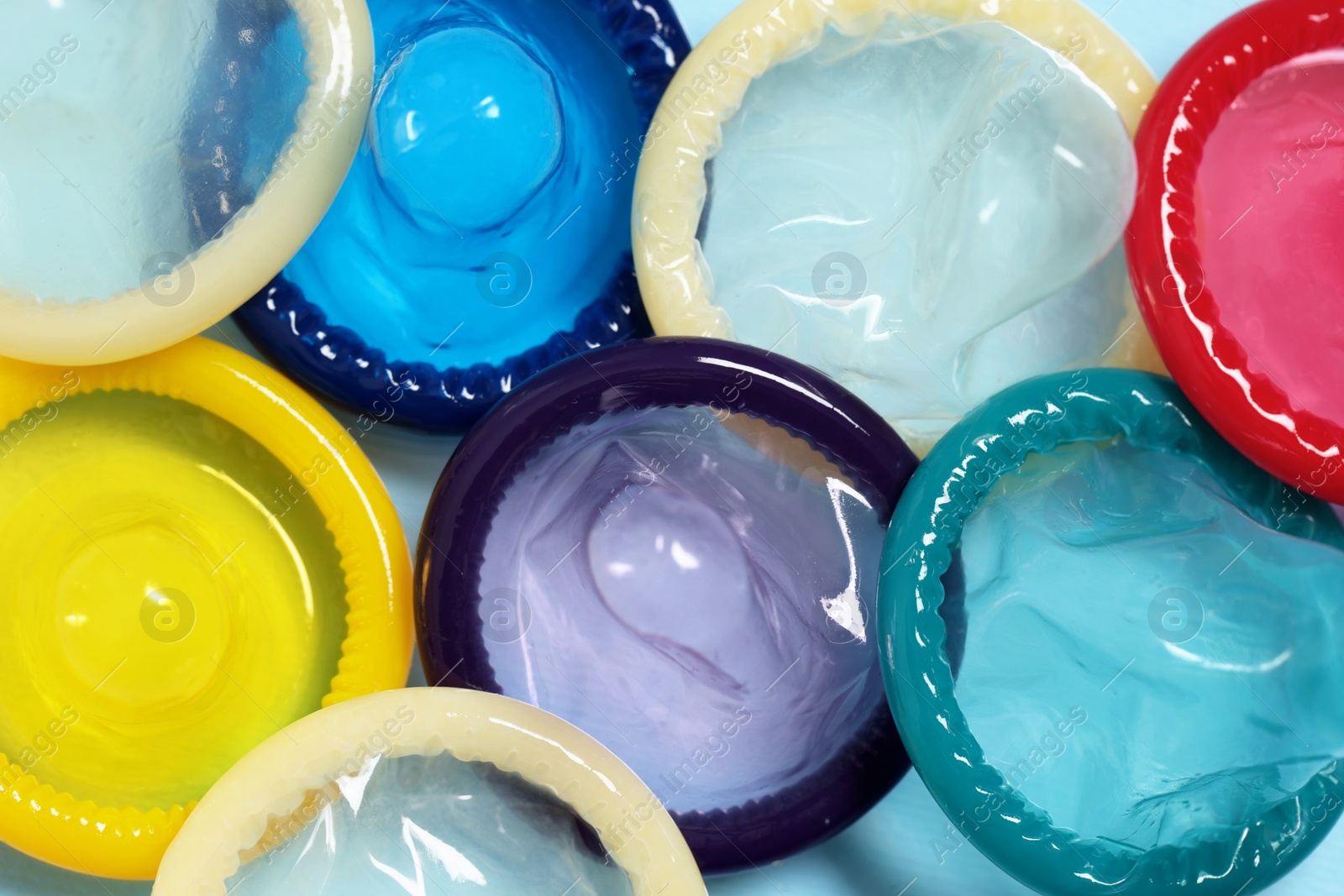 Photo of Condoms on light blue background, top view. Safe sex