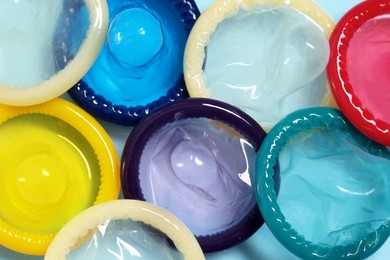 Condoms on light blue background, top view. Safe sex