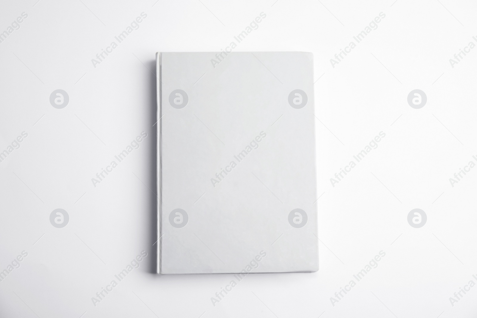 Photo of Book with blank cover on white background, top view