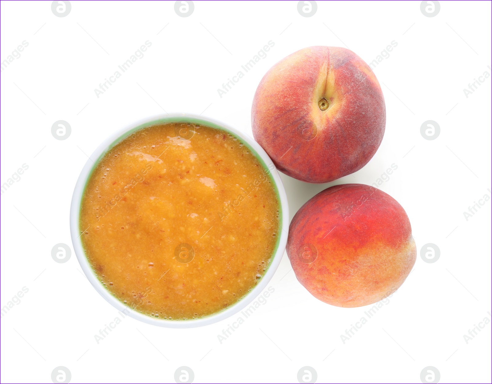 Photo of Peach puree in bowl and fresh fruits on white background, top view