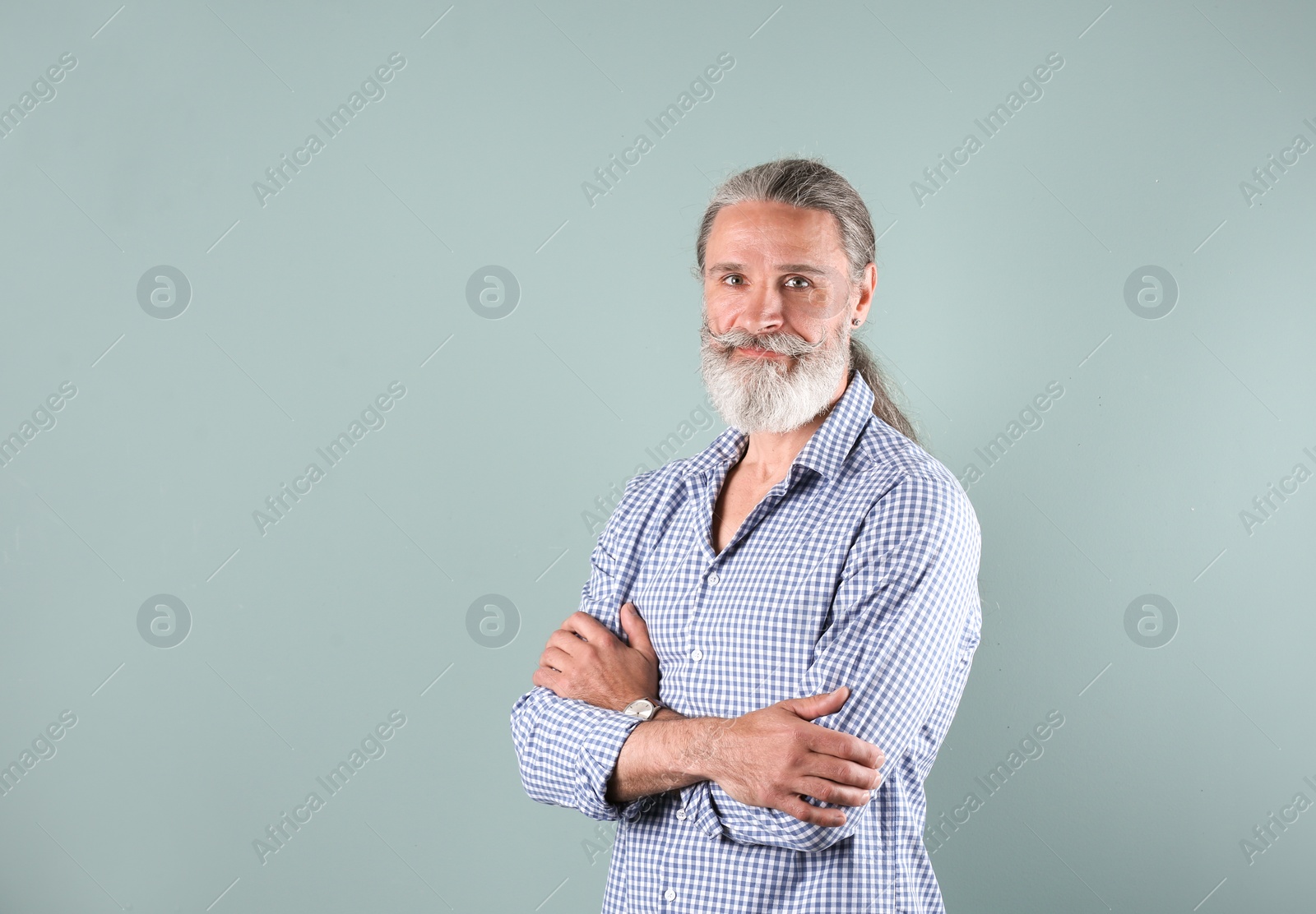 Photo of Portrait of handsome mature man on color background