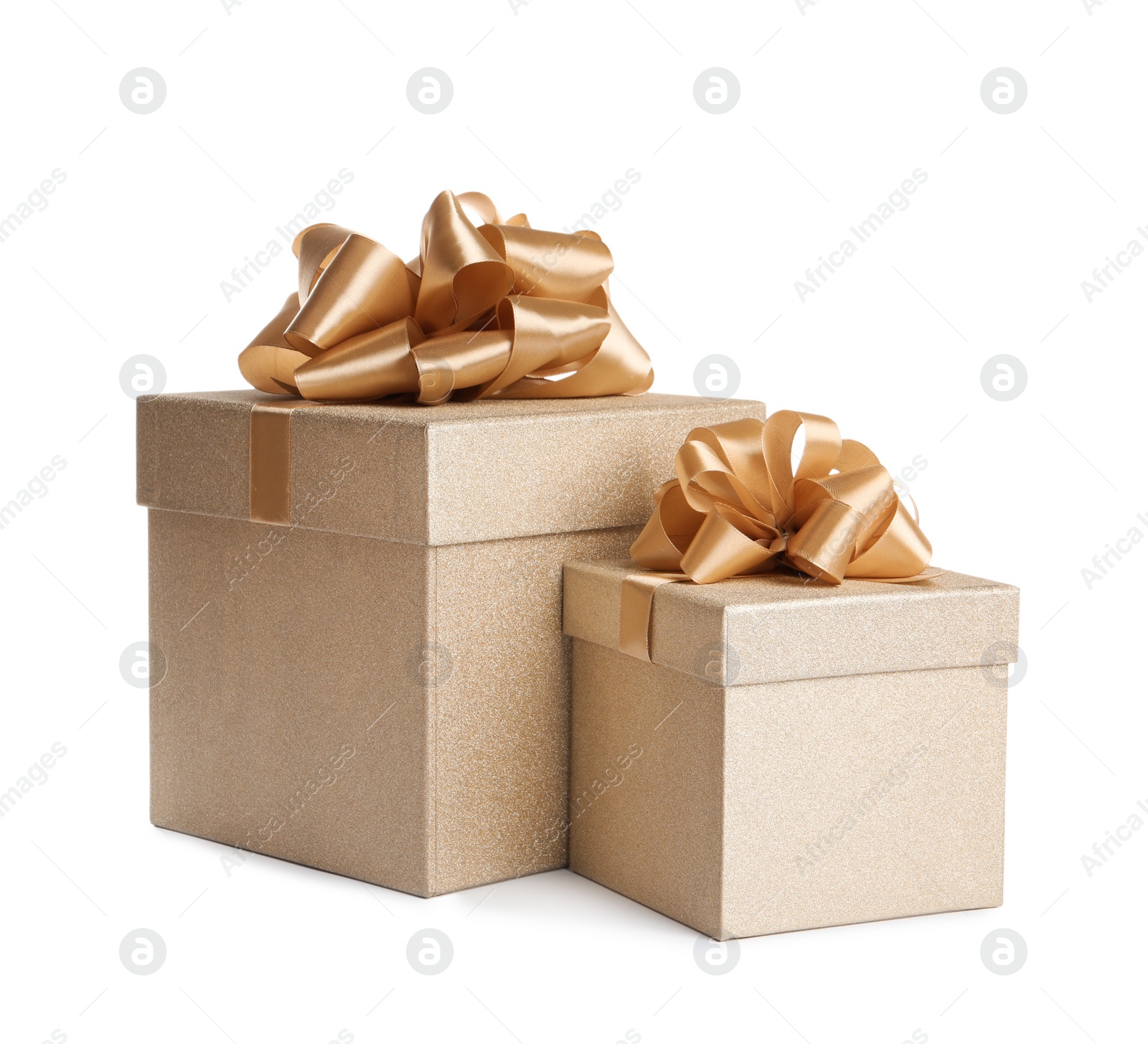 Photo of Golden gift boxes with satin bows on white background