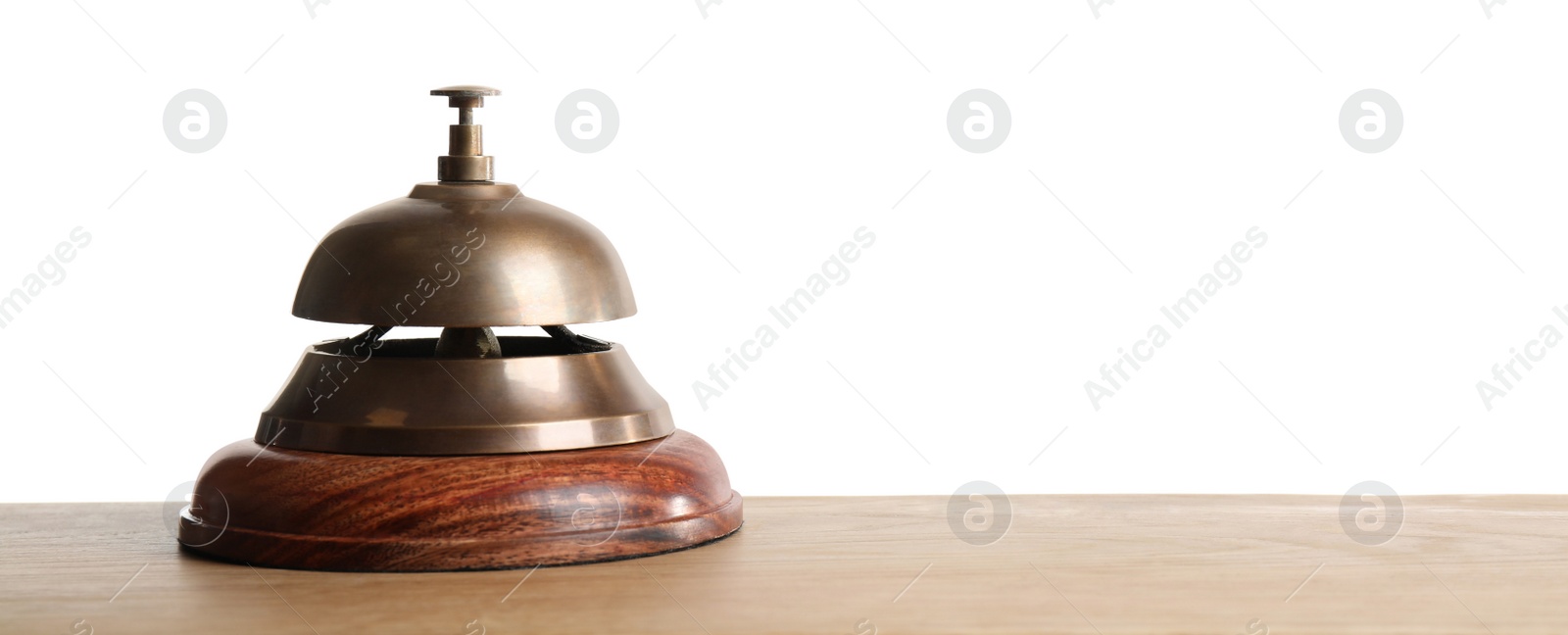 Photo of Hotel service bell on wooden table against white background