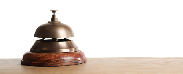 Hotel service bell on wooden table against white background