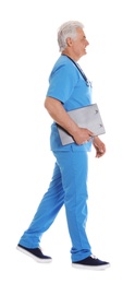 Photo of Full length portrait of male doctor in scrubs with clipboard isolated on white. Medical staff