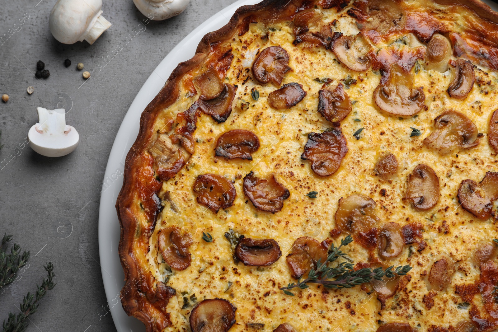 Photo of Delicious homemade mushroom pie on grey table, flat lay