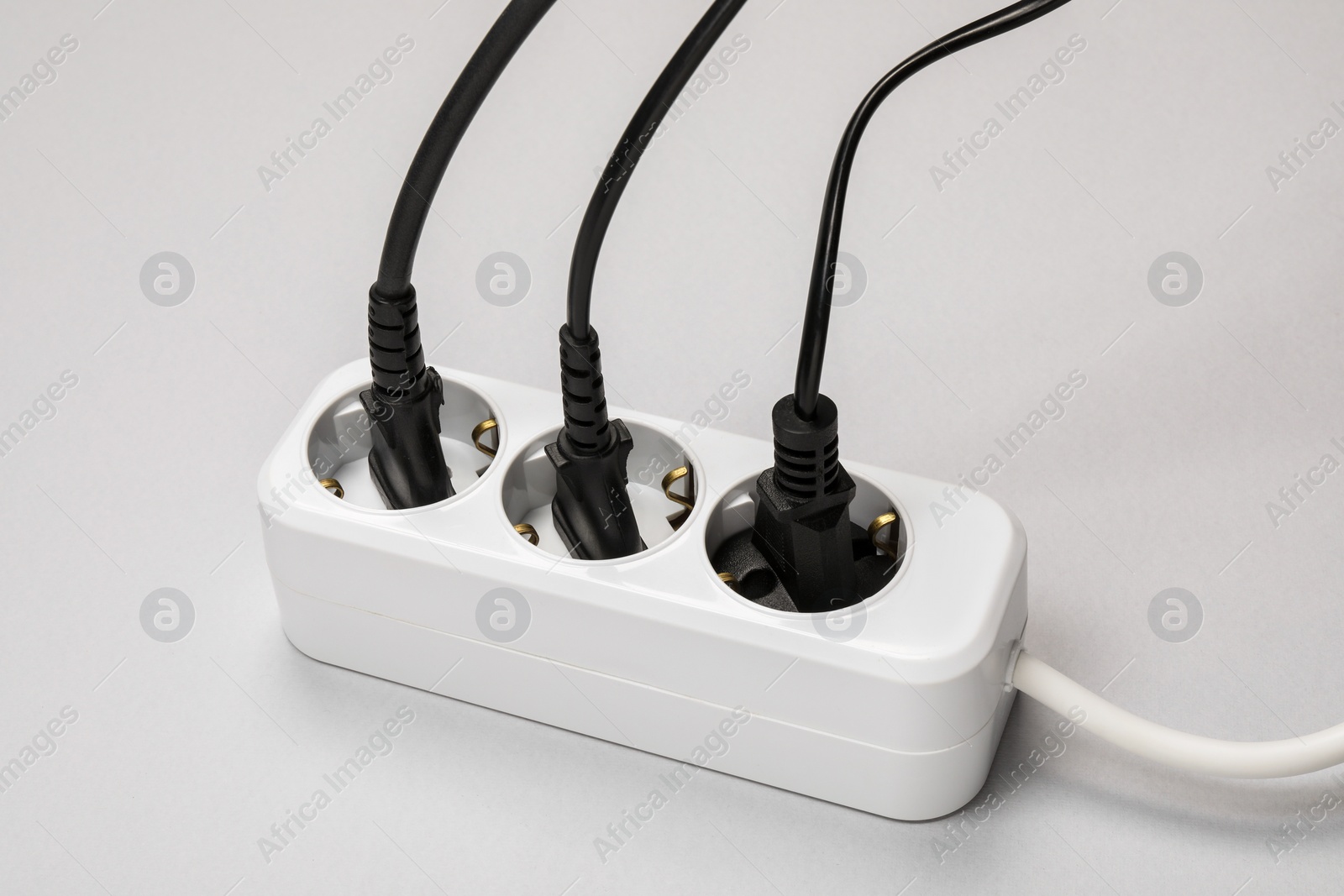 Photo of Power strip with electrical plugs on white background