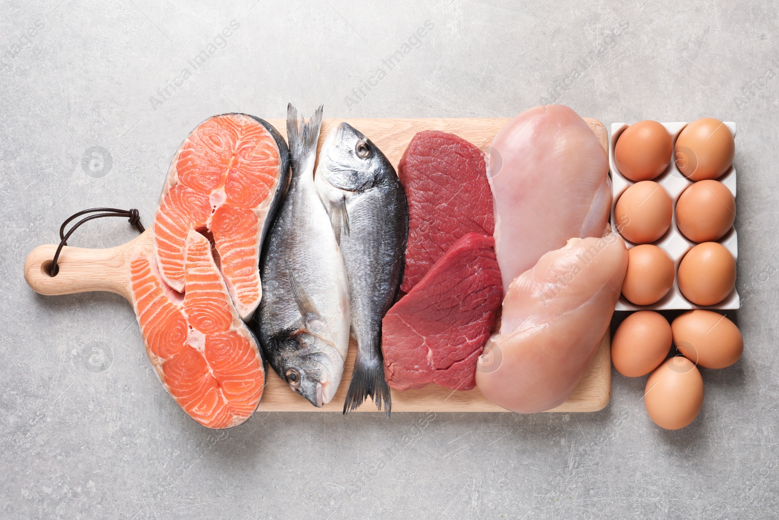 Photo of Set of natural food high in protein on grey background, top view