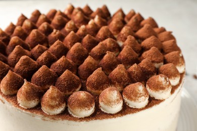 Photo of Delicious tiramisu cake with cocoa powder, closeup