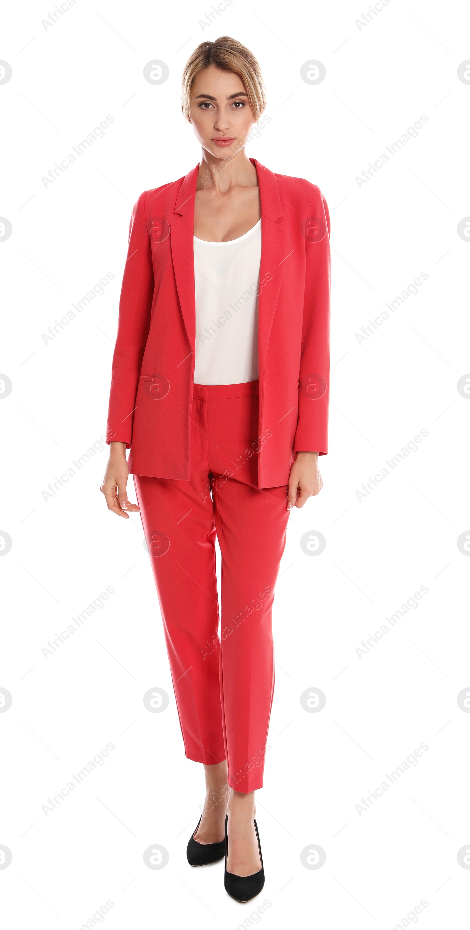 Photo of Beautiful young woman in red suit posing on white background