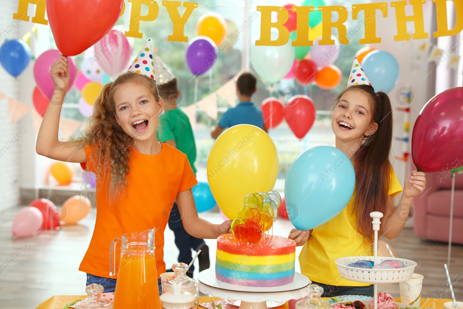 Photo of Happy children at birthday party in decorated room