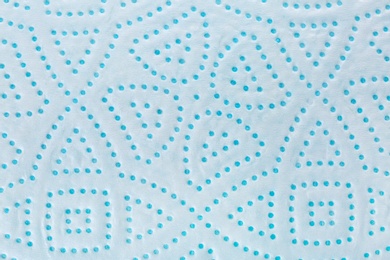 Photo of Perforated toilet paper as background, closeup. Personal hygiene