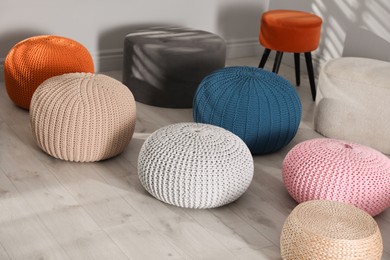 Many stylish different poufs indoors. Home design
