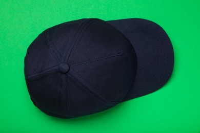 Photo of Baseball cap on green background, top view. Mock up for design