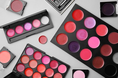 Photo of Flat lay composition with cream lipstick palettes on light grey background. Professional cosmetic product
