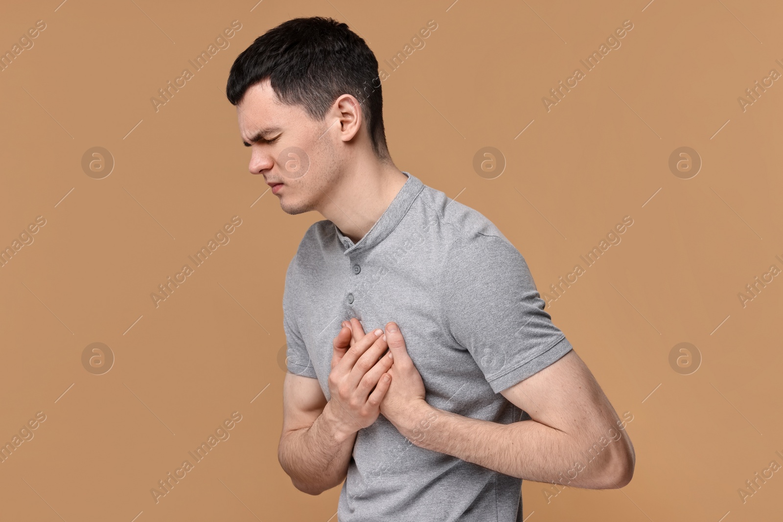 Photo of Man suffering from heart hurt on beige background