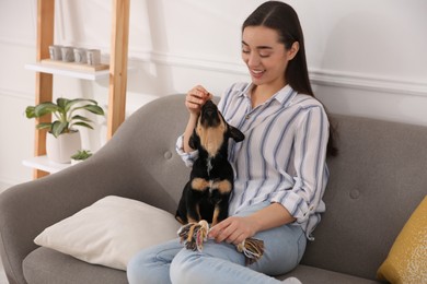 Photo of Woman with cute puppy indoors. Lovely pet