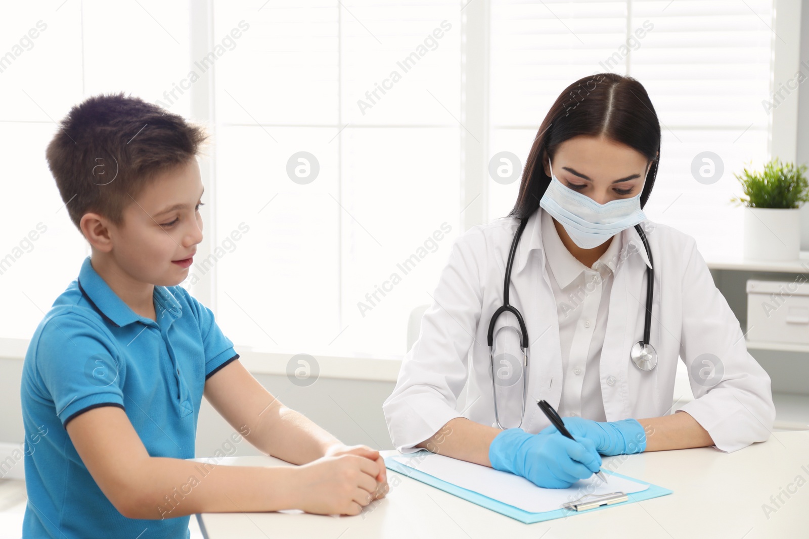 Photo of Doctor examining little patient before vaccination in clinic