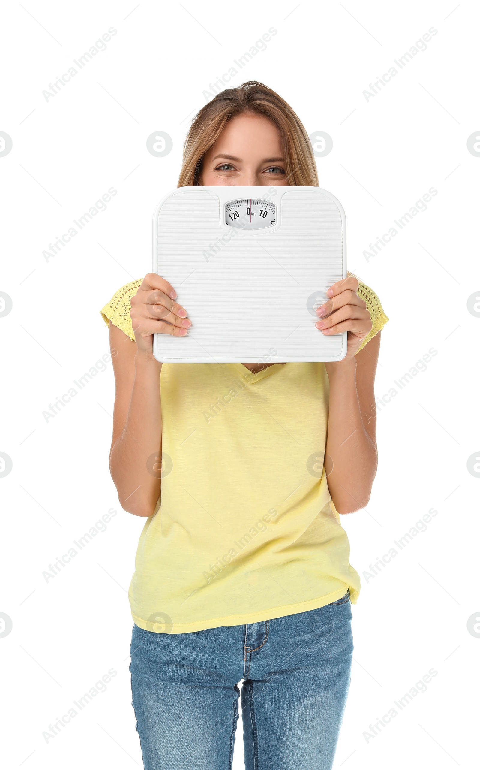 Photo of Happy slim woman satisfied with her diet results holding bathroom scales on white background