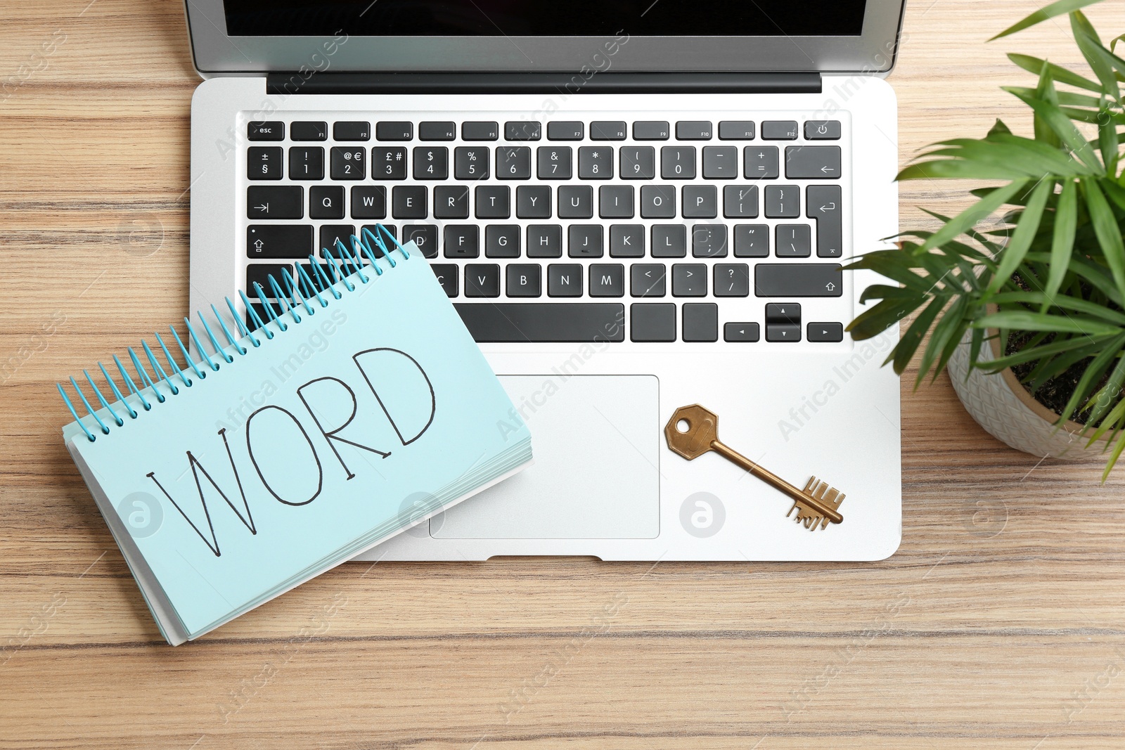 Photo of Flat lay composition with key and laptop on wooden table. Keyword concept