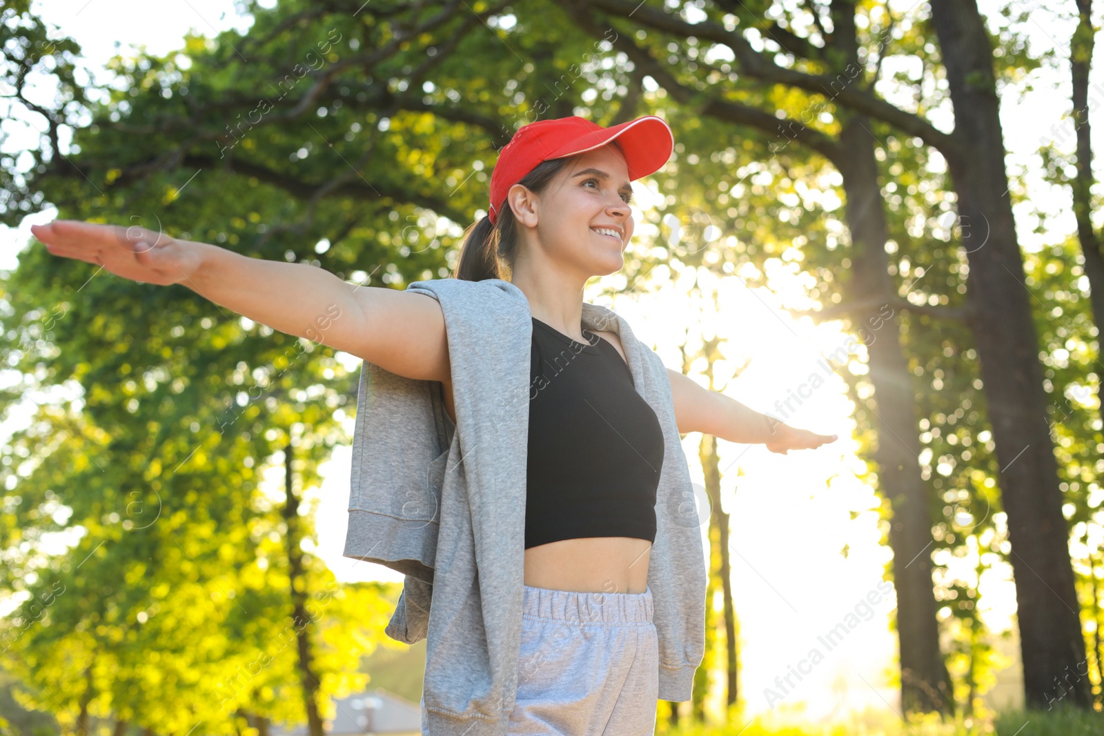 Photo of Young woman doing morning exercise in park