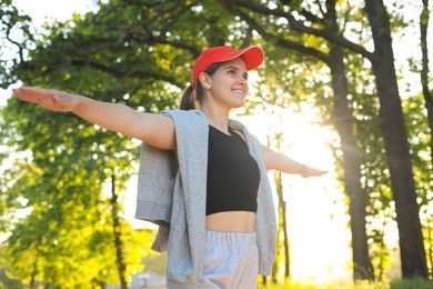 Photo of Young woman doing morning exercise in park