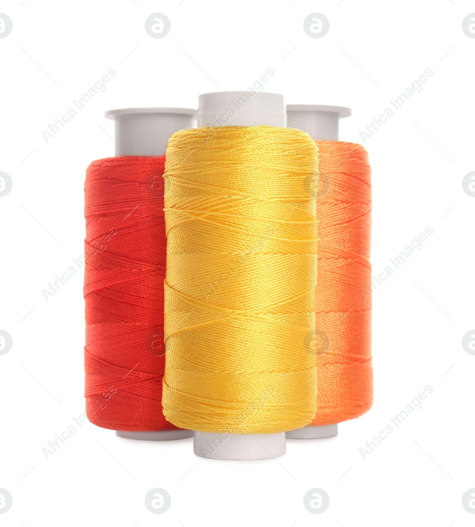 Photo of Different colorful sewing threads on white background