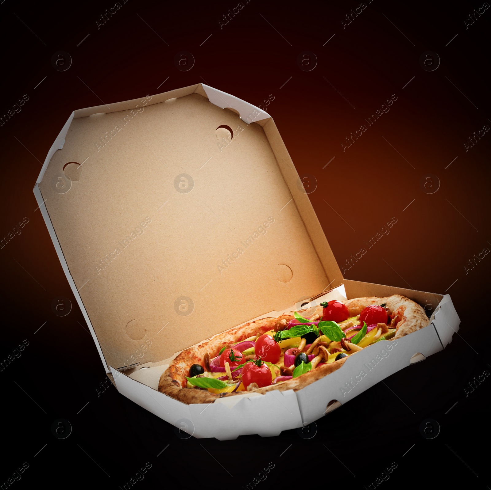 Image of Hot tasty vegetable pizza in cardboard box on dark background. Image for menu or poster