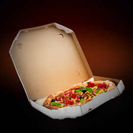 Hot tasty vegetable pizza in cardboard box on dark background. Image for menu or poster
