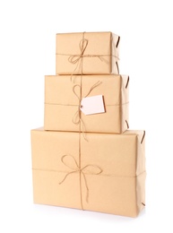 Photo of Stacked parcels wrapped in kraft paper on white background