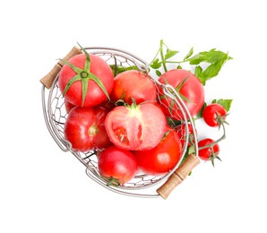 Photo of Many ripe tomatoes with leaves in metal basket on white background, top view