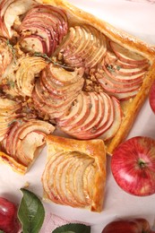 Tasty apple pie with nuts and fresh fruits on table, flat lay