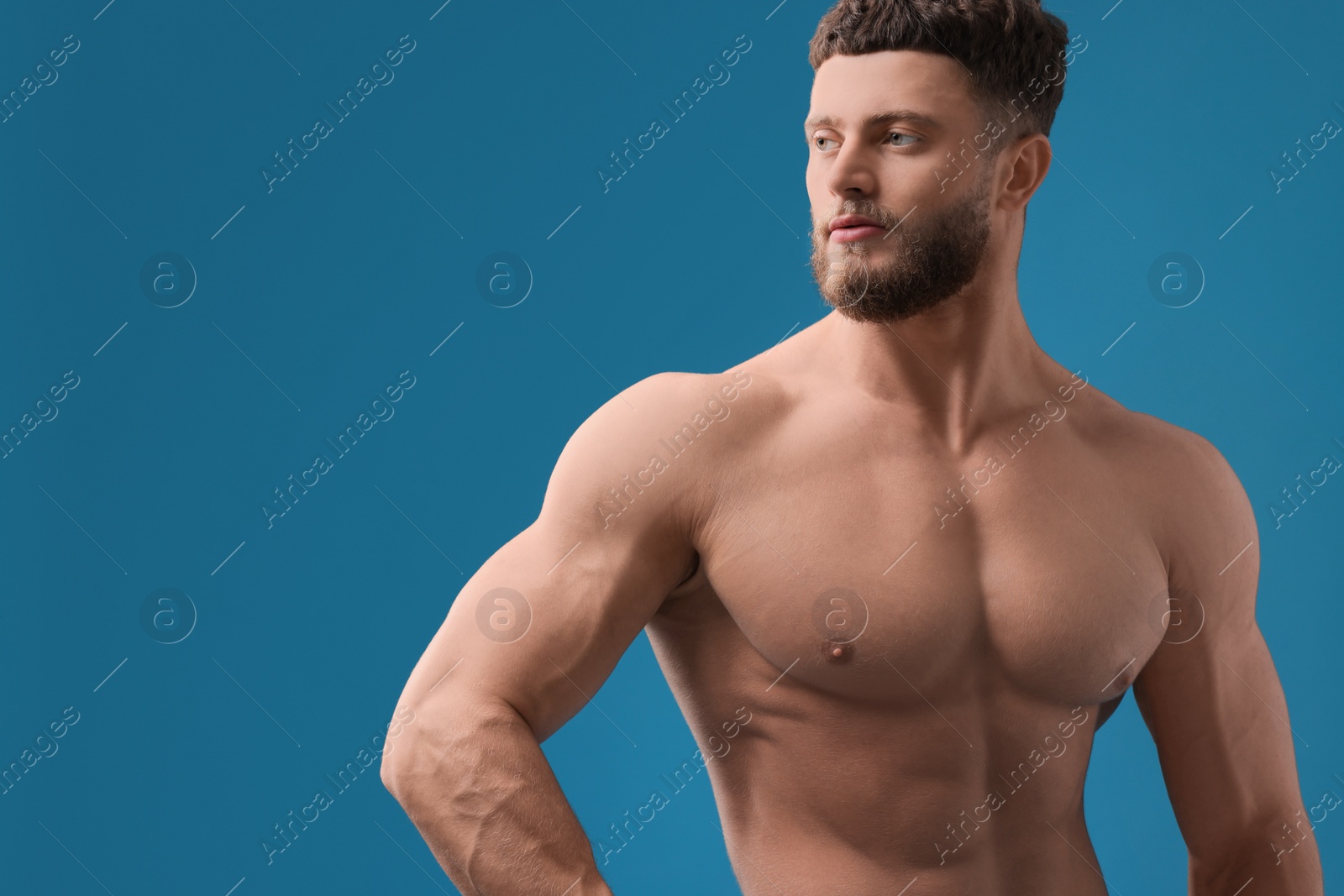 Photo of Handsome muscular man on light blue background, space for text. Sexy body