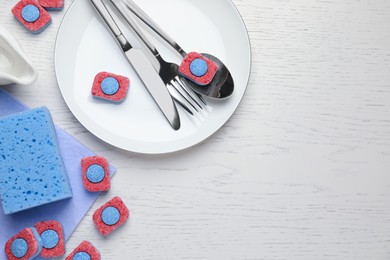 Photo of Flat lay composition with dishwasher detergent tablets on white wooden table, space for text