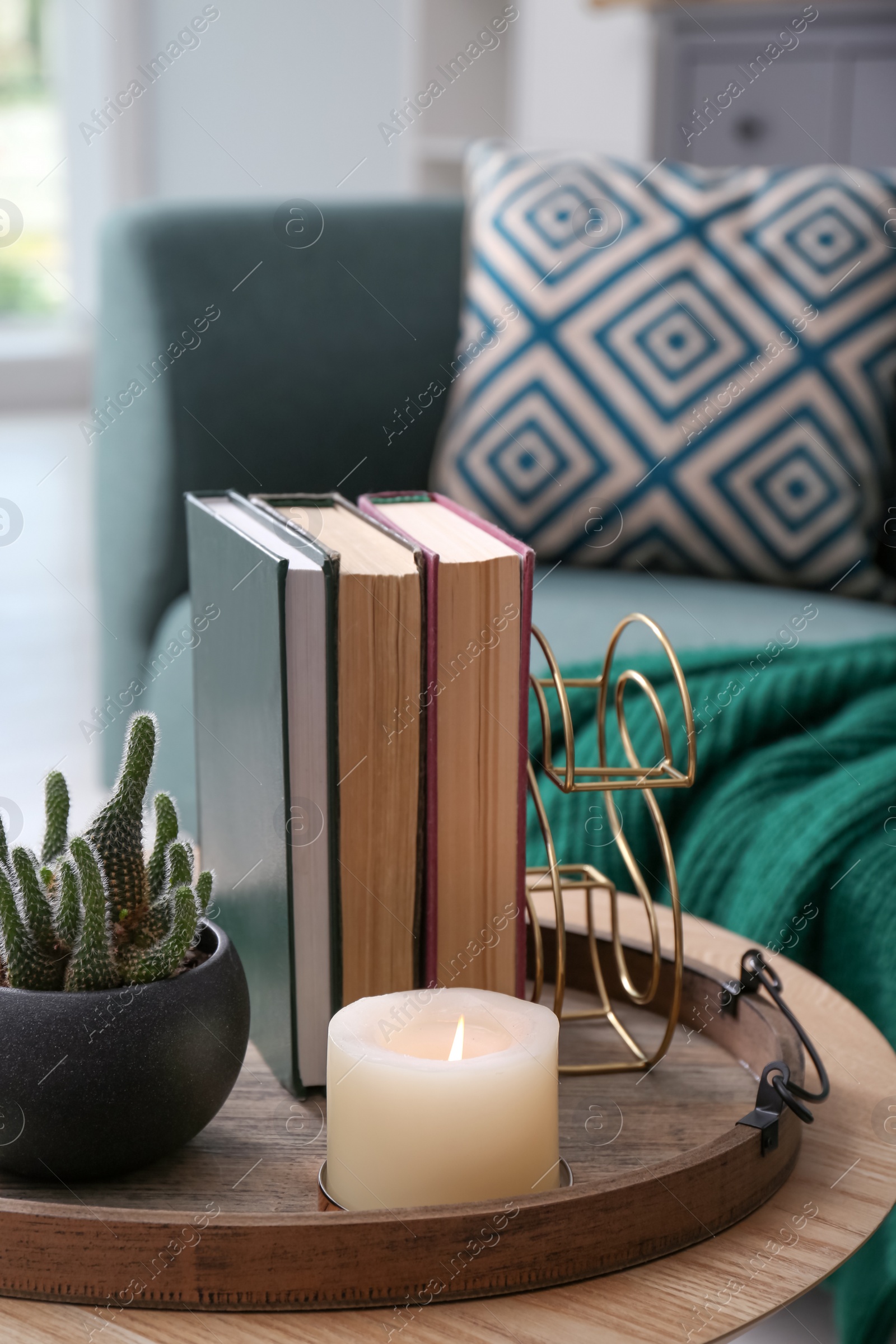 Photo of Stylish tray with different interior elements on wooden table in room