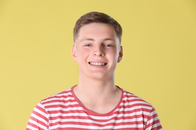 Portrait of teenage boy on yellow background